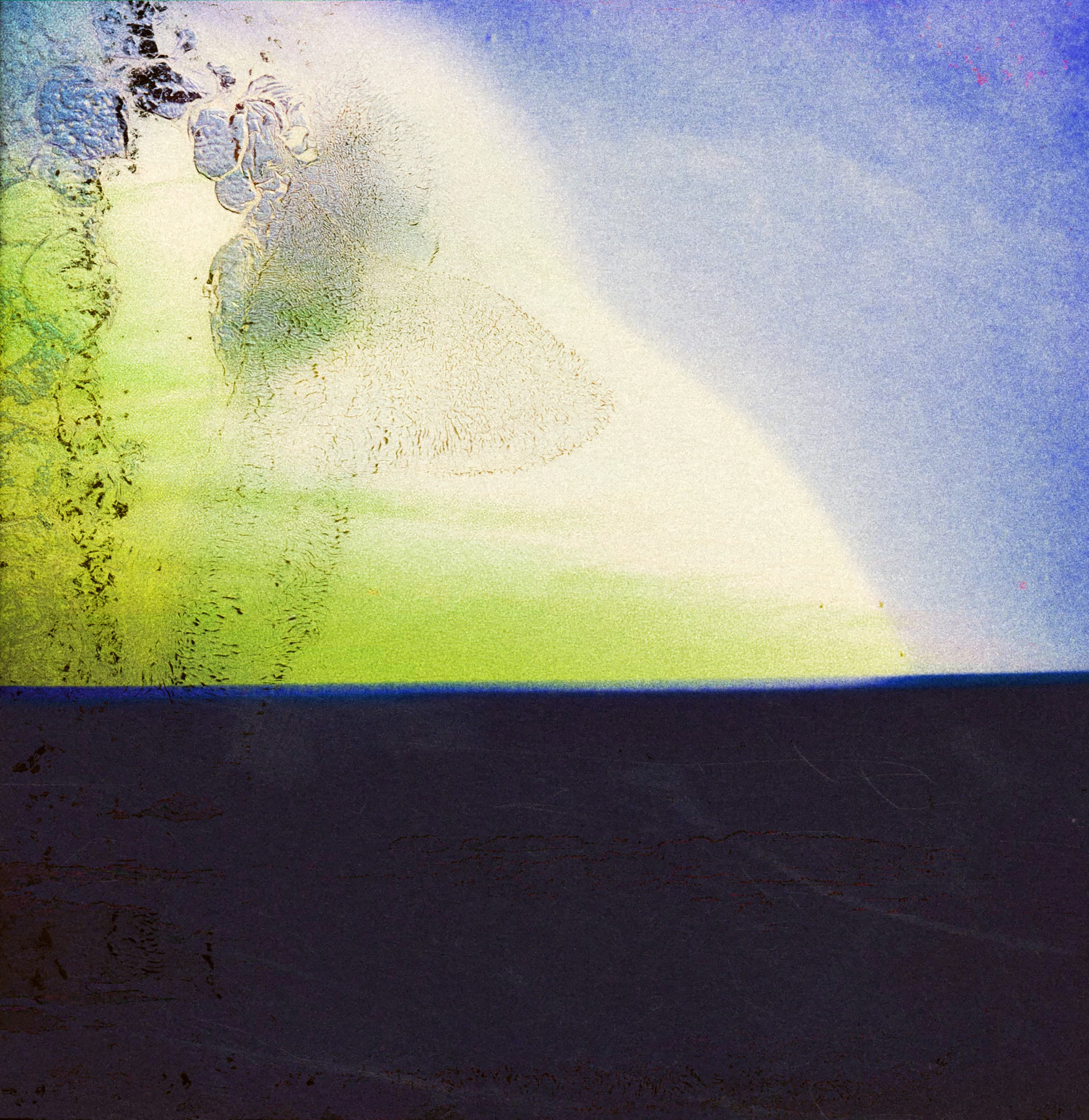 Abstract blue and green light seen through a textured surface above a dark plane.